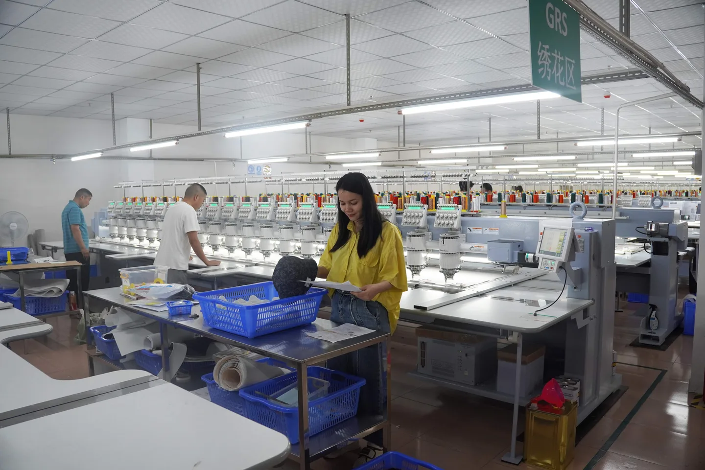 Rows of Barudan embroidery heads running caps on the in-house production line